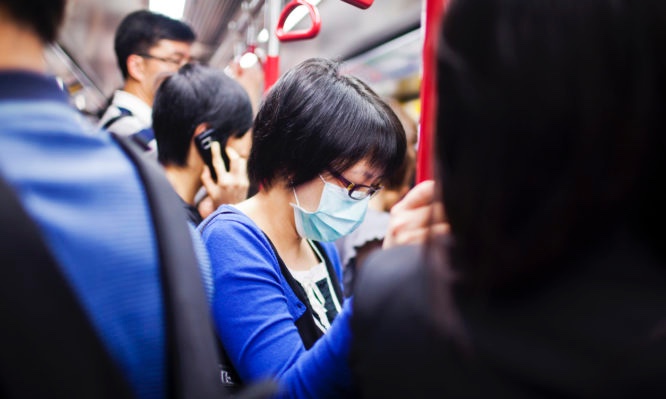 Woman with mask in subway train