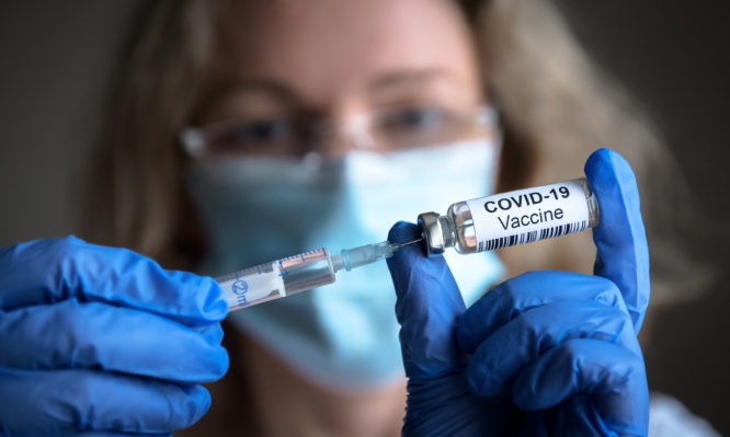 COVID-19 coronavirus vaccine in doctor hands